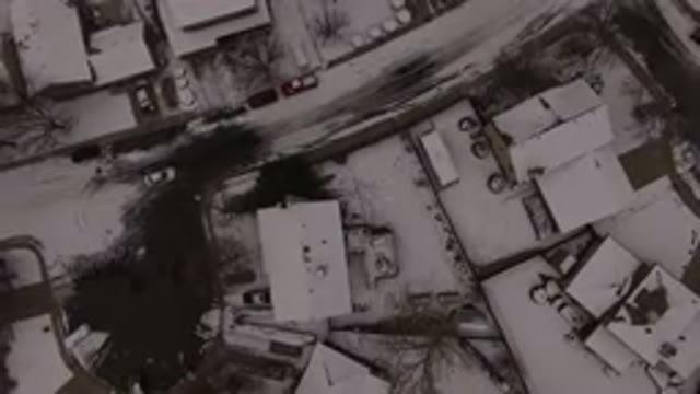 JEFFERSON COUNTY COLORADO-2015: Single Care Driving Down A Snowy Street In An