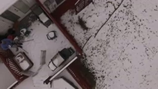 JEFFERSON COUNTY COLORADO-2015: A Man Standing On His Porch Fully Covered With Snow