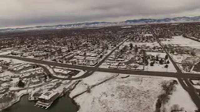JEFFERSON COUNTY COLORADO-2015: Snowy Winter Scene with Roaming Cars and Snowboarding