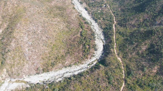 SAN DIONISIO BCS MEXICO-2023: Winding River Flowing Through Grassland and Forest