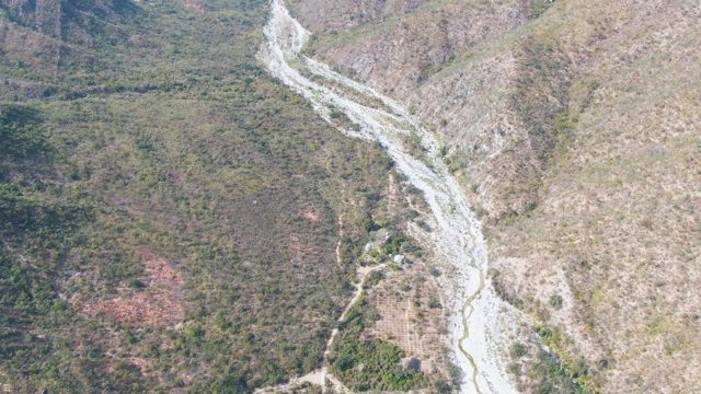 SAN DIONISIO BCS MEXICO-2023: Mountain Valley River with Moving Figure on Path