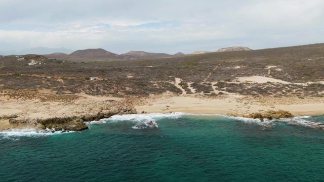 SHIPWRECKS EAST CAPE BCS MEXICO-2023: Sandy Beach with People and Rocky Coastline