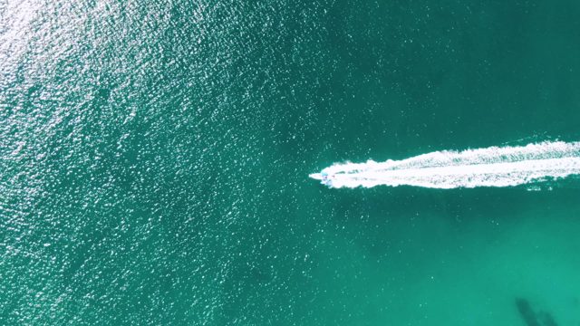 BUZZARDS BEACH EAST CAPE BCS MEXICO-2023: Speedboat Leaving White Wake in Turquoise Ocean