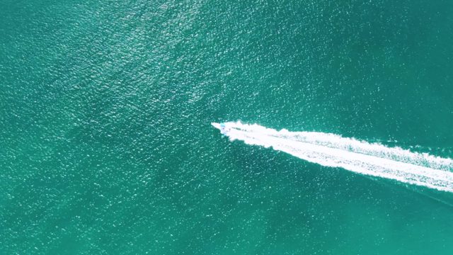 BUZZARDS BEACH EAST CAPE BCS MEXICO-2023: Speedboat Cutting Through Turquoise Ocean Water