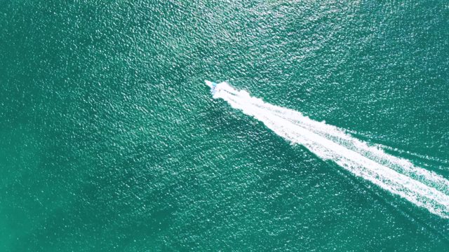 BUZZARDS BEACH EAST CAPE BCS MEXICO-2023: Speedboat Creating White Wake in Turquoise Water