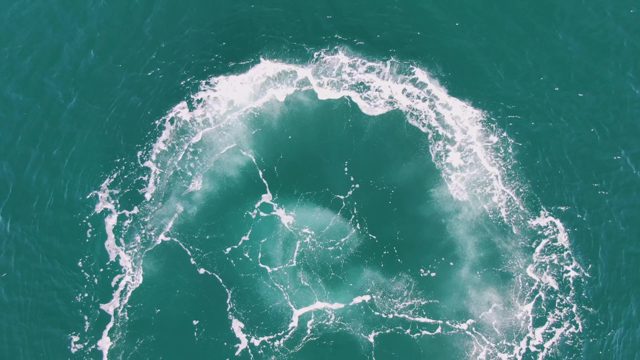 BUZZARDS BEACH EAST CAPE BCS MEXICO-2023: Circular Boat Wake Dissipating in Turquoise Water