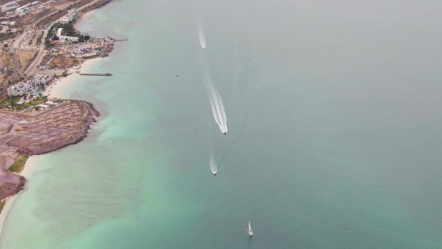 LA PAZ BCS MEXICO-2023: Boats Navigating Coastal Waters near a Sandy Shore