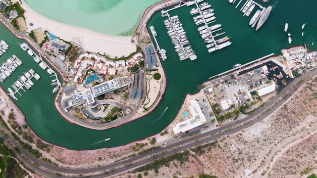 LA PAZ BCS MEXICO-2023: Marina with Moving Boat and Sandy Shore