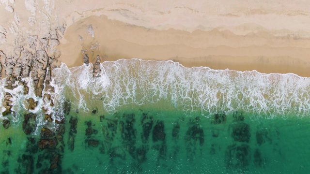PUNTA GORDA BEACH BCS MEXICO-2023: Waves Crashing on Sandy Shore with Rocky Outcrops