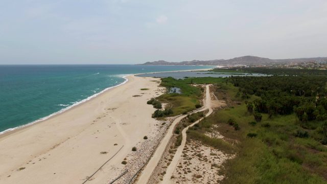 PUERTO LOS CABOS BEACH BCS MEXICO-2023: Coastal Road Along Sandy Beach and Ocean