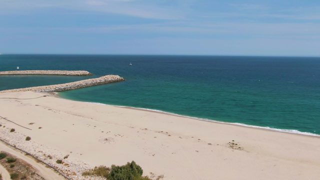 PUERTO LOS CABOS BEACH BCS MEXICO-2023: Sandy Beach with Rocky Breakwater and Dune Path