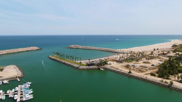 PUERTO LOS CABOS BEACH BCS MEXICO-2023: Marina with Docked Boats and Moving Vessel