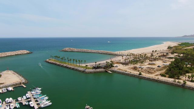PUERTO LOS CABOS BEACH BCS MEXICO-2023: Boat Moving Through Harbor with Docked Yachts