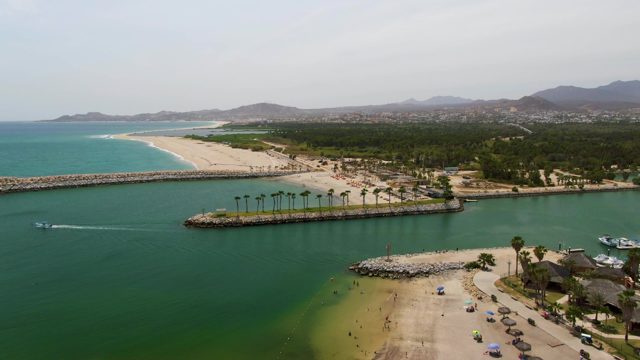 PUERTO LOS CABOS BEACH BCS MEXICO-2023: Boat Moving and Creating Wake in Coastal Harbor