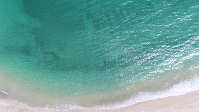 PUERTO LOS CABOS BEACH BCS MEXICO-2023: Gentle Ocean Waves Lapping Sandy Shoreline