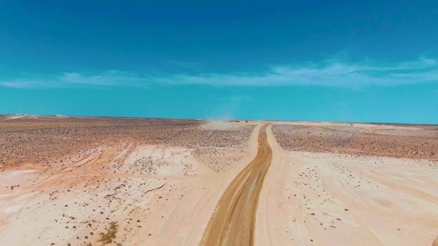 GUERRERO NEGRO BCS MEXICO-2022: Dust Cloud Trailing Along Desert Dirt Road