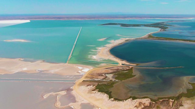 GUERRERO NEGRO BCS MEXICO-2022: Vibrant Turquoise and Blue Salt Lake with Sandy Shores