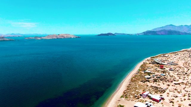 BAHIA DE LOS ANGELES BCS MEXICO-2022: Red Truck Moving Along Sandy Beach