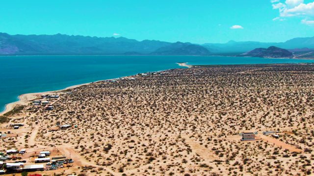BAHIA DE LOS ANGELES BCS MEXICO-2022: Vehicles Moving in Desert Camp near Water