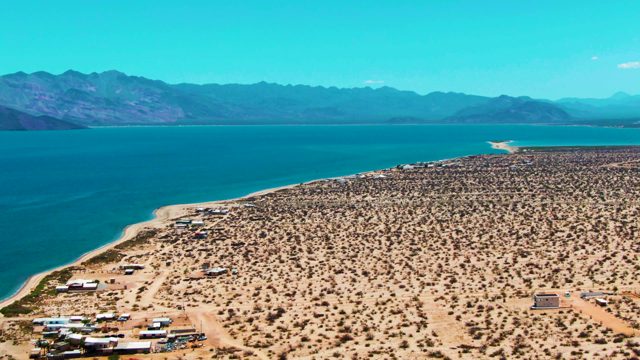 BAHIA DE LOS ANGELES BCS MEXICO-2022: Desert Shoreline with Blue Water and Distant Mountains