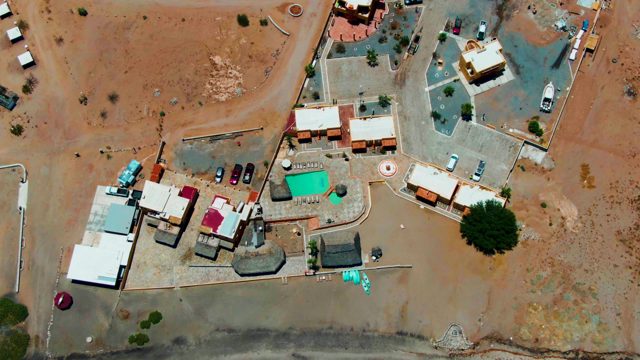 BAHIA DE LOS ANGELES BCS MEXICO-2022: Desert Residential Area with Vehicle Departing