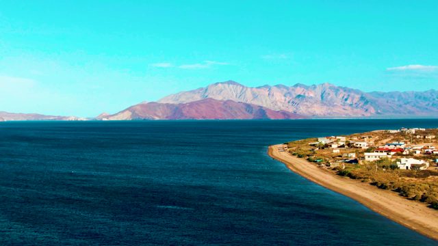 BAHIA DE LOS ANGELES BCS MEXICO-2022: Gentle Ocean Waves Along Mountainous Coastline