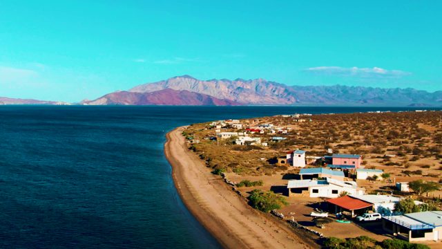 BAHIA DE LOS ANGELES BCS MEXICO-2022: Car Driving Along Coastal Road Near Beach