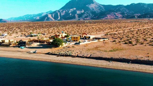 BAHIA DE LOS ANGELES BCS MEXICO-2022: Desert Beach with Mountain Backdrop and Small Settlement