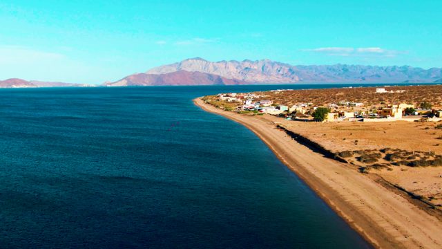 BAHIA DE LOS ANGELES BCS MEXICO-2022: Sandy Beach with Coastal Village and Ocean Waves