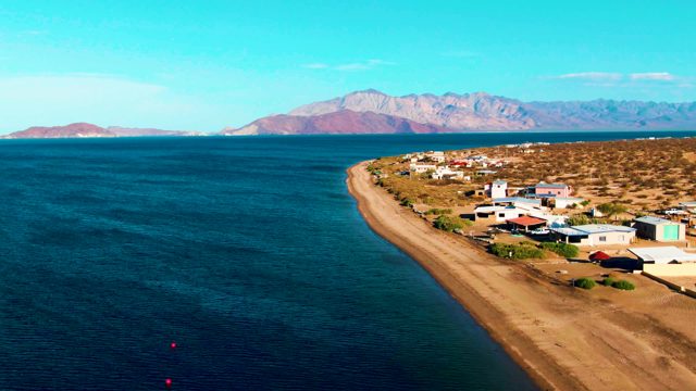 BAHIA DE LOS ANGELES BCS MEXICO-2022: Coastal Settlement Along Sandy Shore and Calm Ocean