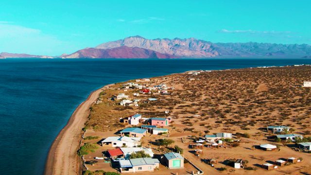 BAHIA DE LOS ANGELES BCS MEXICO-2022: Coastal Settlement with Vehicle Moving Away