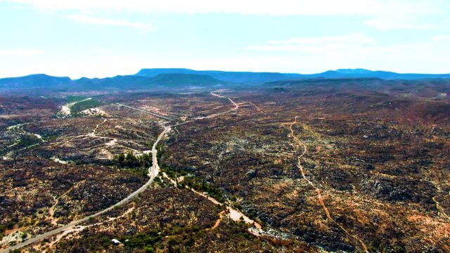 CATAVINA BC MEXICO-2022: Vehicle Moving Along Winding Road in Dry Mountainous Terrain