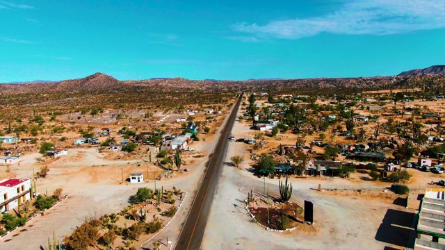 CATAVINA BC MEXICO-2022: Desert Road with Scattered Homes and Cacti