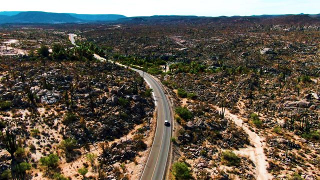 CATAVINA BC MEXICO-2022: Car Moving on a Winding Desert Road