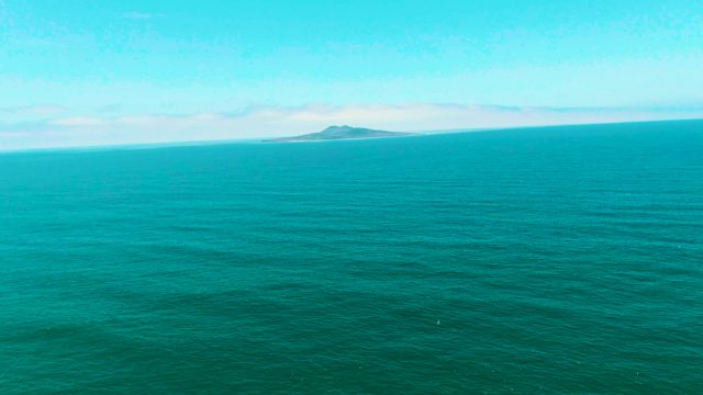 SAN QUINTIN BC MEXICO-2022: Distant Island in Turquoise Ocean Waters