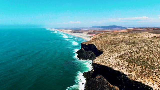 SAN QUINTIN BC MEXICO-2022: Ocean Waves Crashing on Rocky Coastline