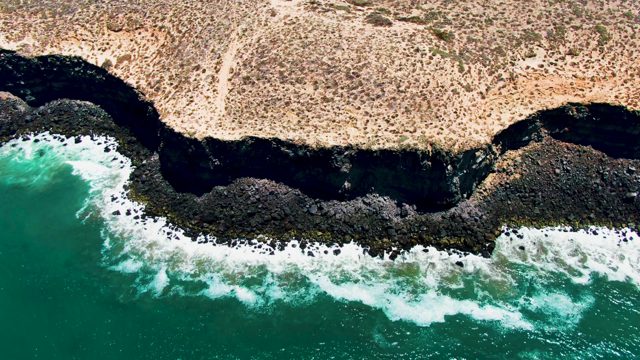 SAN QUINTIN BC MEXICO-2022: Ocean Waves Crashing on Rocky Coastline
