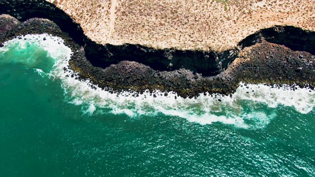 SAN QUINTIN BC MEXICO-2022: Waves Crashing on Rocky Coast From Above