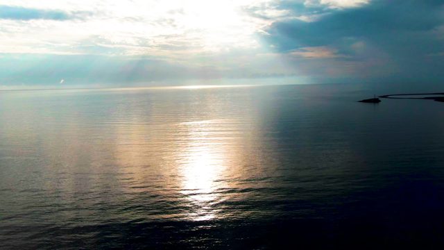 SANTA ROSALIA BCS MEXICO-2022: Sunlight Glinting on Ocean Surface with Distant Structure
