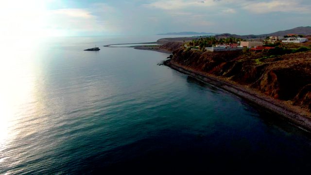 SANTA ROSALIA BCS MEXICO-2022: Coastal Cliff with Buildings and Sunlit Ocean