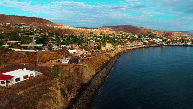 SANTA ROSALIA BCS MEXICO-2022: Aerial Pan of Cliffside Town and Ocean