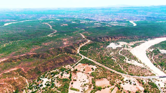 CADUANO BCS MEXICO-2022: Winding River and Road Through Hilly Terrain