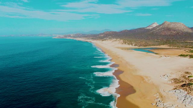 PUNTA BUZZARDS EAST CAPE BCS MEXICO-2022: Gentle Waves Rolling In on a Sandy Beach