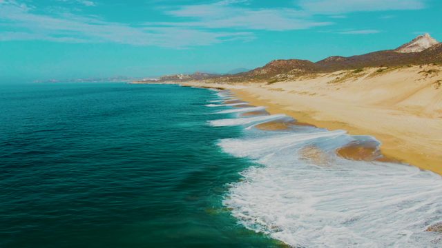 PUNTA BUZZARDS EAST CAPE BCS MEXICO-2022: Ocean Waves Rolling Onto Sandy Shore