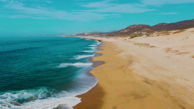 PUNTA BUZZARDS EAST CAPE BCS MEXICO-2022: Waves Gently Rolling Onto a Sandy Beach