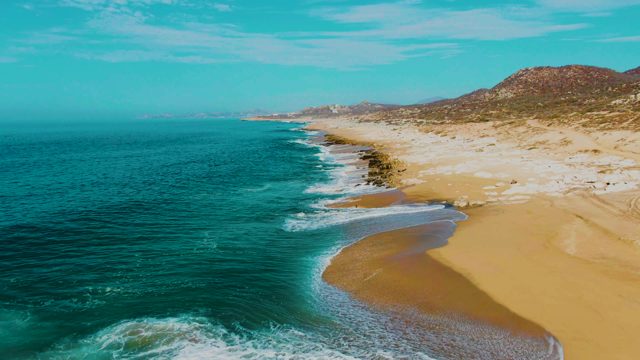 PUNTA BUZZARDS EAST CAPE BCS MEXICO-2022: Ocean Waves Crashing Onto Sandy Shoreline