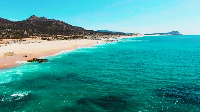PUNTA BUZZARDS EAST CAPE BCS MEXICO-2022: Gentle Ocean Waves Lapping Sandy Beach and Rocks