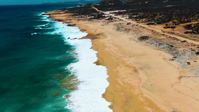 PUNTA BUZZARDS EAST CAPE BCS MEXICO-2022: Waves Rolling Onto Sandy Shore From Above