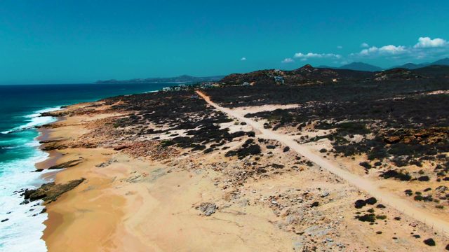 PUNTA BUZZARDS EAST CAPE BCS MEXICO-2022: Sandy Coastline with Ocean Waves and Dirt Road