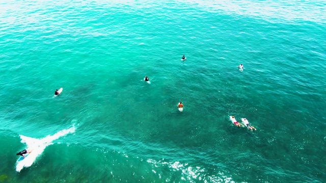 PUNTA BUZZARDS EAST CAPE BCS MEXICO-2022: Surfer Gliding Through Turquoise Ocean Water